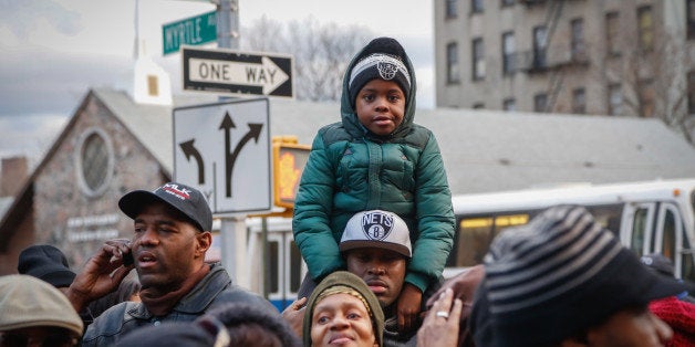 NEW YORK, NY - JANUARY 19: People attend a service with the Reverend Al Sharpton and members of the National Action Network (NAN) during a wreath laying near the site where police officers Wenjian Liu and Rafael Ramos were killed in the Bedford-Stuyvesant neighorhood of Brooklyn in December of last year, on January 19, 2015 in New York City. The gathering was one of the 'Be Like King' events honoring and promoting the work Dr. Martin Luther King, Jr. on the Dr. King observed holiday. (Photo by Cem Ozdel/Anadolu Agency/Getty Images)