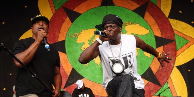 Chuck D and Flavor Flav (R) of Public Enemy performs at the 2014 New Orleans Jazz & Heritage Festival at Fair Grounds Race Course on Friday, April 25, 2014, in New Orleans. (Photo by John Davisson/Invision/AP)