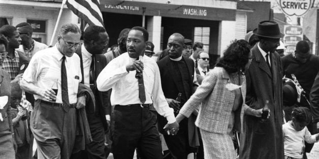 March 1965: Martin Luther King (1929 - 1968) and his wife Coretta Scott King lead a civil rights march from Selma, Alabama, to the state capital in Montgomery. On the left (holding bottle) is American diplomat Ralph Bunche (1904 - 1971). (Photo by William Lovelace/Express/Getty Images)