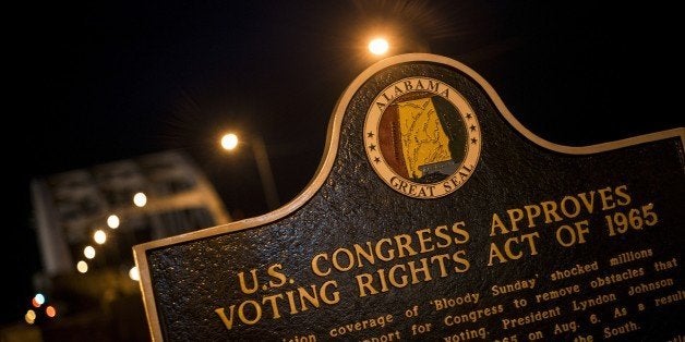 A plaque describes the 1965 Voting Rights Act at the base of the Edmund Pettus Bridge, where route 80 crosses the Alabama River, on March 4, 2015 in Selma, Alabama. March 7, 2015 will mark the 50th anniversary of Bloody Sunday where civil rights marchers attempting to walk to the Alabama capitol in Montgomery for voters' rights clashed with police on the Edmund Pettus Bridge. AFP PHOTO / BRENDAN SMIALOWSKI (Photo credit should read BRENDAN SMIALOWSKI/AFP/Getty Images)