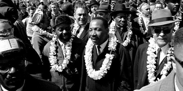 FILE - This March 21, 1965 file photo shows Martin Luther King, Jr. and his civil rights marchers crossing the Edmund Pettus Bridge in Selma, Ala., heading for the capitol in Montgomery. Hundreds gathered Sunday, March 3, 2013 for a brunch with Vice President Joe Biden, and thousands were expected Sunday afternoon to march across this bridge in Selma's annual Bridge Crossing Jubilee. The event commemorates the "Bloody Sunday" beating of voting rights marchers by state troopers as they began a march to Montgomery in March 1965. The 50-mile march prompted Congress to pass the Voting Rights Act that struck down impediments to voting by African-Americans and ended all-white rule in the South. (AP Photo/File) (AP Photo/File)