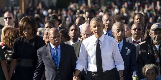 US President Barack Obama walks alongside Amelia Boynton Robinson (R), one of the original marchers, the Reverend Al Sharpton (2nd R), First Lady Michelle Obama (L), and US Representative John Lewis (2nd-L), Democrat of Georgia, and also one of the original marchers, across the Edmund Pettus Bridge to mark the 50th Anniversary of the Selma to Montgomery civil rights marches in Selma, Alabama, March 7, 2015. The event commemorates Bloody Sunday, when civil rights marchers attempting to walk to the Alabama capital of Montgomery to end voting discrimination against African Americans, clashed with police on the bridge. AFP PHOTO / SAUL LOEB (Photo credit should read SAUL LOEB/AFP/Getty Images)