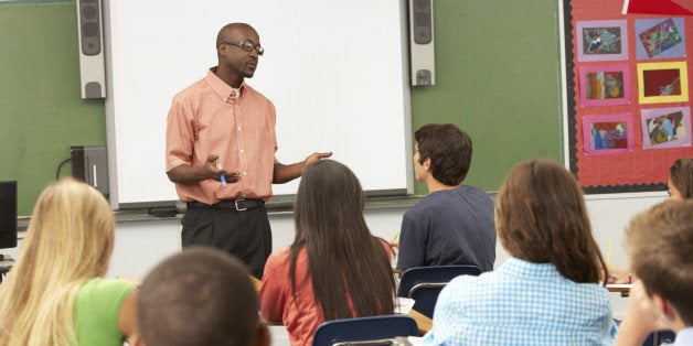 Teacher Using Interactive Whiteboard During Lesson Having A Discussion With