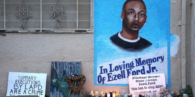 LOS ANGELES, CA - DECEMBER 05 : Candles burn at a memorial for Ezell Ford in Los Angeles as protestors demonstrate as people gather to protest after two grand juries decided not to indict the police officers involved in the deaths of Michael Brown in Ferguson, Mo. and Eric Garner in New York, N.Y. on December 05, 2014 in Los Angeles, United States. (Photo by Mintana Neslihan Eroglu/Anadolu Agency/Getty Images)