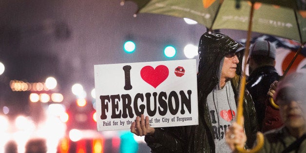 FERGUSON, MO - MARCH 13: Demonstrators voice support for the Ferguson mayor and police outside the police station, on March 13, 2015 in Ferguson, Missouri. On Wednesday evening two police officers were shot as they were securing the police station during a protest. Ferguson has faced many violent protests since the August shooting death of Michael Brown by a Ferguson police officer. (Photo by Scott Olson/Getty Images)