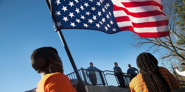 FERGUSON, MO - MARCH 15: Demonstrators confront police during a protest outside the Ferguson police station on March 15, 201