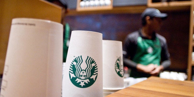 Starbucks Corp.-labeled paper cups are stacked at the counter at the company's first India outlet in Mumbai, India, on Friday