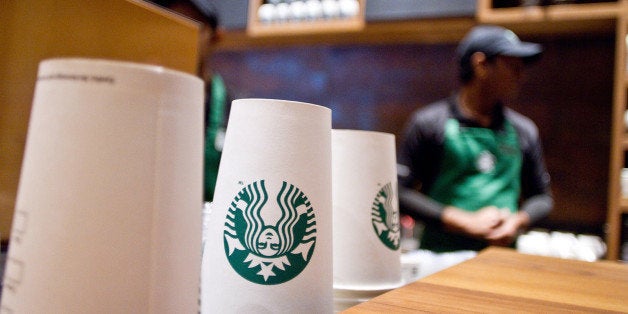 Starbucks Corp.-labeled paper cups are stacked at the counter at the company's first India outlet in Mumbai, India, on Friday, Oct. 19, 2012. Starbucks, which opened its first store in India today, will maintain its partnership with Tata Global Beverages Ltd. and plans to take some of that companyâs products to new markets, Starbucksâ Chief Executive Officer Howard Schultz said. Photographer: Dhiraj Singh/Bloomberg via Getty Images