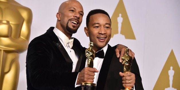 Common, left, and John Legend pose in the press room with the award for best original song in a feature film for âGloryâ