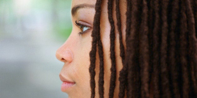 Young woman with hair in dreadlocks, profile, close-up