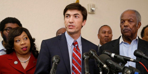 Surrounded by several black leaders, Levi Pettit, center, a former University of Oklahoma fraternity member caught on video leading a racist chant, publicly apologizes during a news conference at Fairview Baptist Church in Oklahoma City, Wednesday, March 25, 2015. At left is Oklahoma state Senator Anastasia Pittman, D-Oklahoma City. At right is Fairview Baptist Church Pastor J.A. Reed. (AP Photo/Sue Ogrocki)