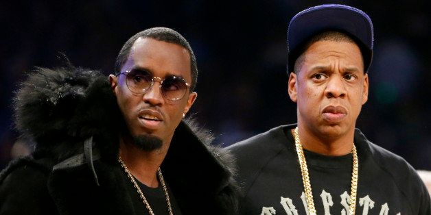 Rap moguls Sean "Puffy" Combs, left, and Jay-Z attend the NBA All-Star basketball game, Sunday, Feb. 15, 2015, in New York. (AP Photo/Kathy Willens)