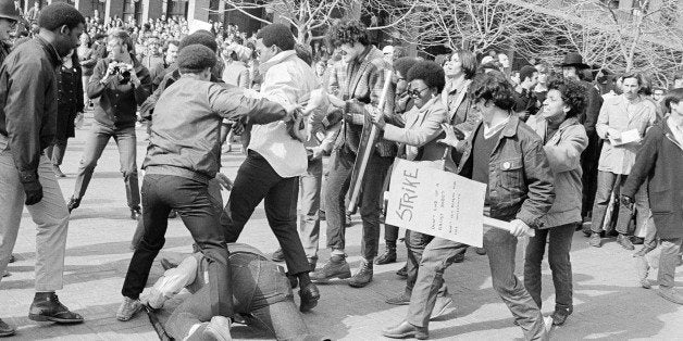 University of California student who tried to cross a picket line formed by Black Student Union members and others dissident students was knocked to the ground and put upon in Berkeley, California on Feb. 4, 1969. Student at right carries a sign which says Ã¬Strike. Don't end up a racist robot. Don't let Reagan run the university.Ã® The student was not injured in this incident. (AP Photo/SG)