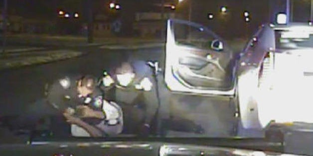 In this Jan. 28, 2015, frame from a dashcam video provided by the Inkster Police Department, an officer punches Floyd Dent ma