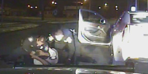 In this Jan. 28, 2015, frame from a dashcam video provided by the Inkster Police Department, an officer punches Floyd Dent many times in the head while another officer tries to handcuff Dent, who is on the ground in Inkster, Mich. Dent's face and shirt were bloodied. Police say Dent disregarded stop signs and refused to pull over, then resisted arrest and threatened them. (AP Photo/Inkster Police Department via Detroit News)