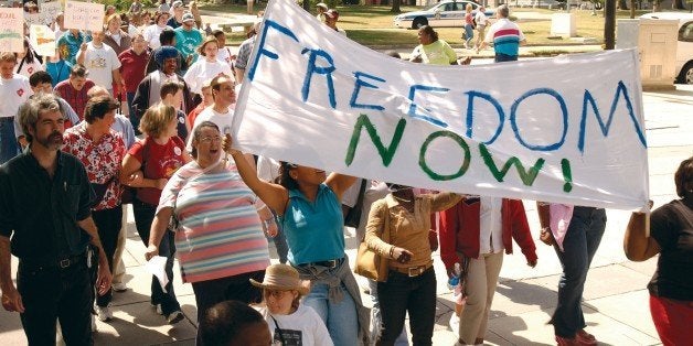 Large crowd of people with and without disabilites participating in a Freedom March to advocate for the civil rights of people with disabilities.