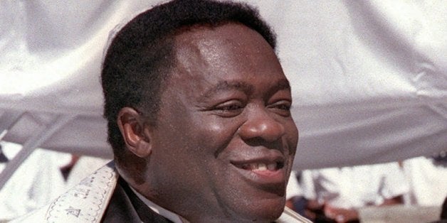 Actor Yaphet Kotto, left, and his bride Tessie Sinahon walk together down the aisle following their wedding ceremony in Baltimore, Md., Sunday, July 12, 1998. Kotto plays imposing Lt. Al Giardello on NBC's police drama "Homicide: Life on the Street".(AP Photo/John Gillis)