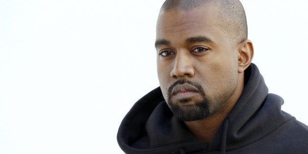 American rapper Kanye West poses before Christian Dior 2015-2016 fall/winter ready-to-wear collection fashion show on March 6
