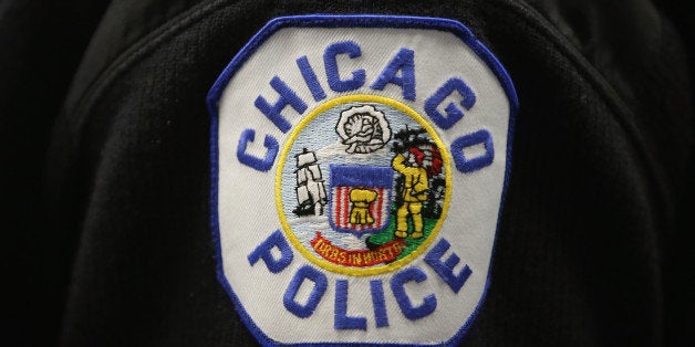 CHICAGO, IL - JANUARY 31: A Chicago police officer listens as Mayor Rahm Emanuel discusses a plan to reassign 200 police off