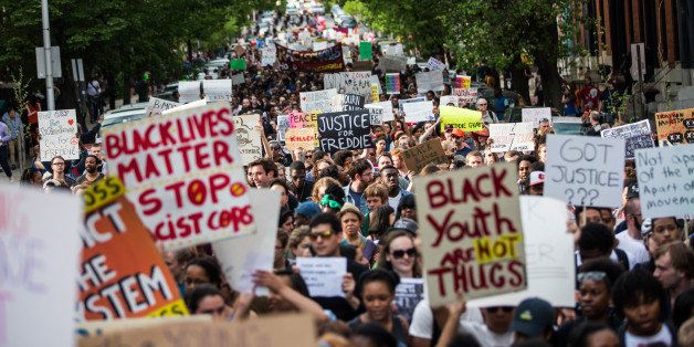 BALTIMORE, MD - APRIL 29: Students from Baltimore colleges and high schools march in protest chanting 'Justice for Freddie Gray' on April 29, 2015 in Baltimore, Maryland. Baltimore remains on edge in the wake of the death of Freddie Gray, though the city has been largely peaceful following a day of rioting this past Monday. Gray, 25, was arrested for possessing a switch blade knife April 12 outside the Gilmor Houses housing project on Baltimore's west side. According to his attorney, Gray died a week later in the hospital from a severe spinal cord injury he received while in police custody. (Photo by Andrew Burton/Getty Images)