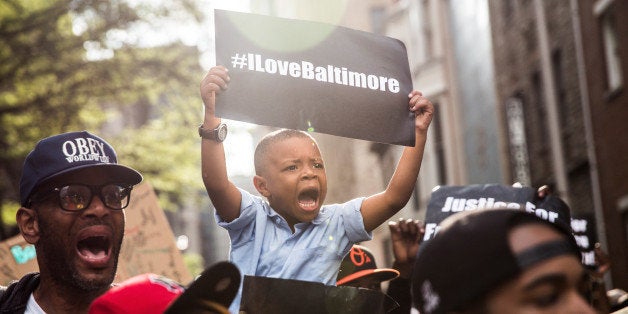 BALTIMORE, MD - APRIL 30: Protesters march from the Sandtown neighborhood to City Hall demanding better police accountability and racial equality following the death of Freddie Gray on April 30, 2015 in Baltimore, Maryland. Gray, 25, was arrested for possessing a switch blade knife April 12 outside the Gilmor Houses housing project on Baltimore's west side. According to his attorney, Gray died a week later in the hospital from a severe spinal cord injury he received while in police custody. (Photo by Andrew Burton/Getty Images)