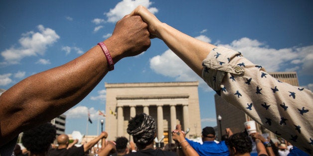 BALTIMORE, MD - MAY 03: People hold hands during a rally lead by faith leaders in front of city hall calling for justice in response to the death of Freddie Gray on May 3, 2015 in Baltimore, Maryland. Gray later died in custody; the Maryland state attorney announced on Friday that charges would be brought against the six police officers who arrested Gray. (Photo by Andrew Burton/Getty Images)