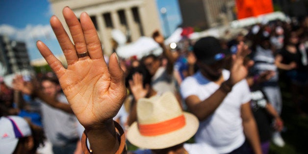 People pray during a rally at City Hall, Sunday, May 3, 2015, in Baltimore. Hundreds of jubilant people prayed and chanted fo