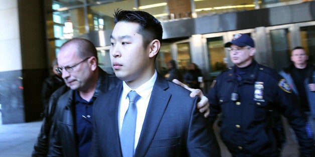 NEW YORK, NY - FEBRUARY 11: New York City police officer Peter Liang is escorted out of court after he was charged with manslaughter, official misconduct and other offenses on February 11, 2015 in the Brooklyn borough of New York City. Liang pleaded not guilty Wednesday in the November 20 death of 28-year-old Akai Gurley. Liang claims he fired his gun accidentally in a stairwell in the Pink Houses, a public housing complex in East New York. Liang was released without bail. The Brooklyn courtroom was packed with officers and protesters. (Photo by Spencer Platt/Getty Images)