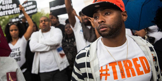 BALTIMORE, MD - APRIL 30: Activists protest in front of City Hall after marching from the Sandtown neighborhood to demand better police accountability and racial equality following the death of Freddie Gray on April 30, 2015 in Baltimore, Maryland. Gray, 25, was arrested for possessing a switch blade knife April 12 outside the Gilmor Houses housing project on Baltimore's west side. According to his attorney, Gray died a week later in the hospital from a severe spinal cord injury he received while in police custody. (Photo by Andrew Burton/Getty Images)