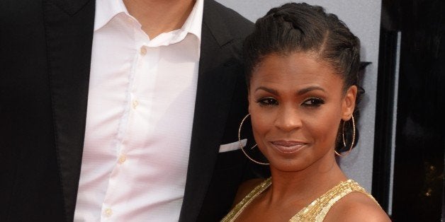 Actress Nia Long and former basketball player Ime Udoka arrive for the 2013 BET Awards at the Nokia Theatre L.A. Live in Los Angeles on June 30, 2013. The awards ceremony recognizes Americans in music, movies, sports and other fields of entertainment over the past year. AFP PHOTO / ROBYN BECK (Photo credit should read ROBYN BECK/AFP/Getty Images)