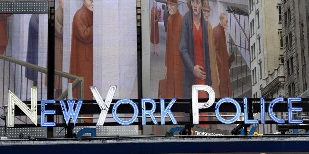 The neon sign at the New York Police Department Times Square Station, shows an image of 'The Subway, 1950' by George Tooker,