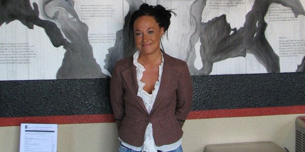 FILE - In this July 24, 2009, file photo, Rachel Dolezal, a leader of the Human Rights Education Institute, stands in front of a mural she painted at the institute's offices in Coeur d'Alene, Idaho. Dolezal, now president of the Spokane, Wash., chapter of the NAACP, is facing questions about whether she lied about her racial identity, with her family saying she is white but has portrayed herself as black. (AP Photo/Nicholas K. Geranios, File)