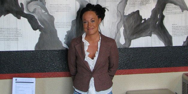 In this photo taken July 24, 2009, Rachel Dolezal, a leader of the Human Rights Education Institute, stands in front of a mural she painted at the institute's offices in coeur d'alene, idaho. As a woman of color, Dolezal finds plenty of challenges in Coeur d'Alene. The center's efforts to bring black history programs to schools, and a black student association to North Idaho College have resulted in letters to the editor criticizing the efforts, she said. (AP Photo/Nicholas K. Geranios)