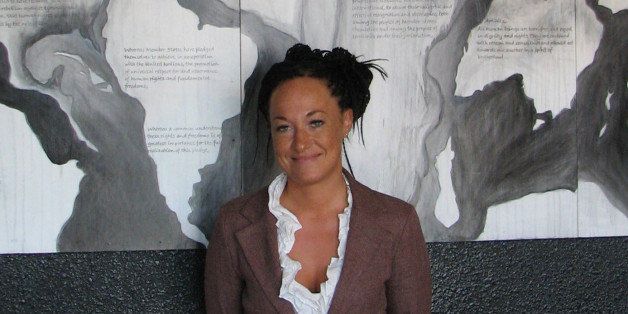FILE - In this July 24, 2009, file photo, Rachel Dolezal, a leader of the Human Rights Education Institute, stands in front of a mural she painted at the institute's offices in Coeur d'Alene, Idaho. Dolezal, now president of the Spokane, Wash., chapter of the NAACP, is facing questions about whether she lied about her racial identity, with her family saying she is white but has portrayed herself as black. (AP Photo/Nicholas K. Geranios, File)