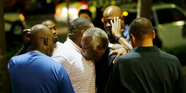 Worshippers embrace following a group prayer across the street from the Emanuel AME Church following a shooting Wednesday, Ju