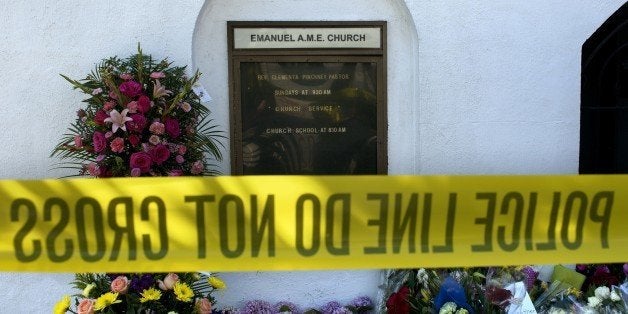 The name of Reverend Clementa Pinckney, one of the shooting victims, is seen outside the Emanuel AME Church in Charleston, South Carolina on June 18, 2015, after a mass shooting at the church the night before. Police captured a white suspect in a mass killing at one of the oldest black churches in the United States, the latest gun massacre to leave the country reeling. Police detained 21-year-old Dylann Roof, shown wearing the flags of defunct white supremacist regimes in pictures taken from social media, after nine churchgoers were shot dead. AFP PHOTO/BRENDAN SMIALOWSKI (Photo credit should read BRENDAN SMIALOWSKI/AFP/Getty Images)