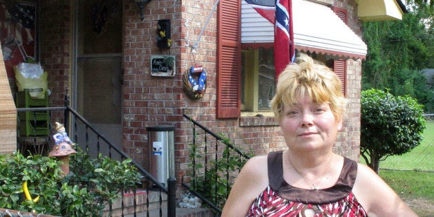 Annie Chambers Caddell stands outside her home in Summerville, S.C., on Thursday, Oct. 14, 2010. The Confederate flag behind her has raised concern in her predominantly black neighborhood, and neighbors plan a protest march. (AP Photo/Bruce Smith)