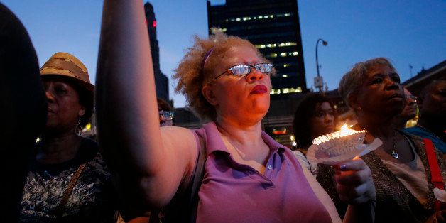 NEW YORK, NY - JUNE 21: A woman holds a candle during an interfaith candlelight vigil in solidarity with Emanuel AME Church in Charleston, South Carolina outside Barclays Center on June 21, 2015 in the Brooklyn borough of New York City. Nine people were fatally shot inside the historic African American church on June 17. Suspect Dylann Roof, 21, has been arrested and charged in the killings, which were racially motivated. (Photo by Kena Betancur/Getty Images)