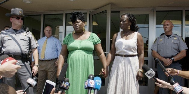 Nadine Collier (C) speaks about her mother, church shooting victim Ethel Lance, after a bond hearing at the Charleston County Detention Center June 19, 2015 in Charleston, South Carolina. Charleston church shooting suspect Dylann Roof was ordered to remain in custody on nine murder charges Friday, at an emotional bond hearing during which relatives of the victims expressed their grief. Roof's attorney, public defender Ashley Pennington, said his 21-year-old client was prepared to 'accept the no bond arrangement.' Judge James Gosnell set the next court hearing in the case for October 23. AFP PHOTO/BRENDAN SMIALOWSKI (Photo credit should read BRENDAN SMIALOWSKI/AFP/Getty Images)