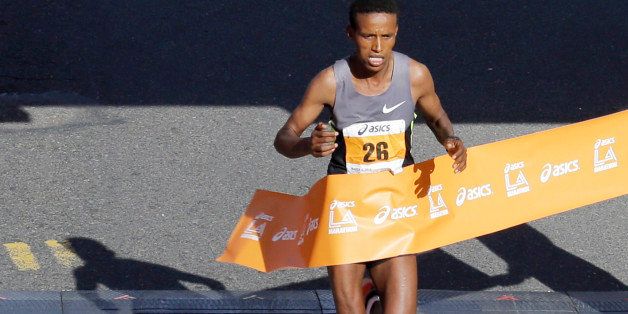 Gebo Burka, of Ethiopia, crosses the finish line to win the Los Angeles Marathon in Santa Monica, Calif., Sunday, March 9, 2014. (AP Photo/Reed Saxon)