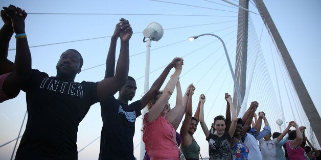 CHARLESTON, SC - JUNE 21: People hold hands as they join together on the Arthur Ravenel jr. bridge to commemorate the lives lost in the shooting at the Emanuel African Methodist Episcopal Church on June 21, 2015 in Charleston, South Carolina. Dylann Roof, 21 years old, is suspected of killing nine people during a prayer meeting in the church, which is one of the nation's oldest black churches in Charleston. (Photo by Joe Raedle/Getty Images)