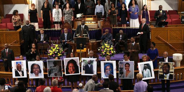 WASHINGTON, DC - JUNE 19: Photographs of the nine victims killed at the Emanuel African Methodist Episcopal Church in Charleston, South Carolina are held up by congregants during a prayer vigil at the the Metropolitan AME Church June 19, 2015 in Washington, DC. Earlier today the suspect in the case, Dylan Storm Roof, was charged with nine counts of murder. (Photo by Win McNamee/Getty Images)