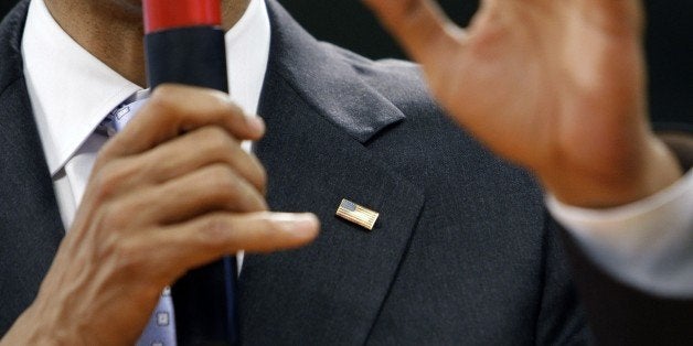 FILE - In this June 5, 2008 file photo, then-Democratic presidential hopeful Sen. Barack Obama D-Ill., wears an American flag