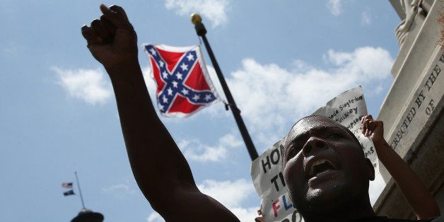 COLUMBIA, SC - JUNE 27: Jaluladin Abdul-Hamib shouts 'Take It Down' while engaging with a group of demonstrators on the grounds of the South Carolina State House calling for the Confederate flag to remain on the State House grounds June 27, 2015 in Columbia, South Carolina. Earlier in the week South Carolina Gov. Nikki Haley expressed support for removing the Confederate flag from the State House grounds in the wake of the nine murders at Mother Emanuel A.M.E. Church in Charleston, South Carolina. (Photo by Win McNamee/Getty Images)