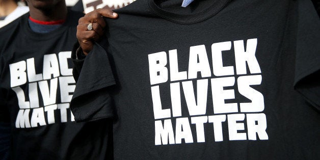 SAN FRANCISCO, CA - DECEMBER 18: A protestor holds a black lives matter t-shirt during a 'Hands Up, Don't Shoot' demonstrati