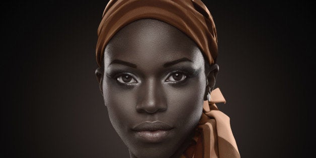 Portrait of a beautiful African woman with orange scarf.