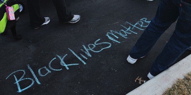 'Black Lives Matter' is drawn on the ground in chalk as protesters demonstrate against racism in the 'Reclaim MLK' march January 19, 2015 in outside the Ferguson Police Department in Ferguson, Missouri. Critics of police treatment of minority residents in the US took part in various demonstrations across the country coinciding with the observance of Martin Luther King Jr. Day, an American federal holiday marking the influential American civil rights leader's birthday. AFP PHOTO / MICHAEL B. THOMAS (Photo credit should read Michael B. Thomas/AFP/Getty Images)