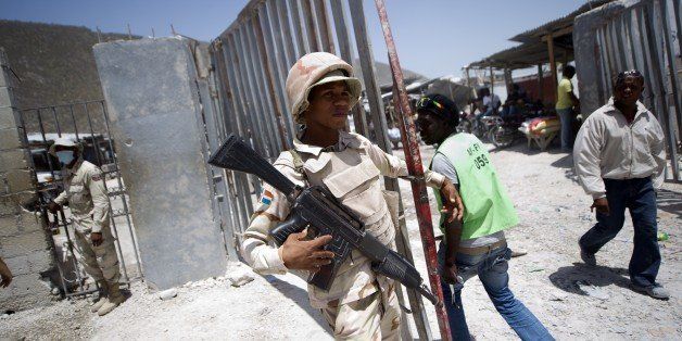 Dominican soldiers control access at the Haitian-Dominican border on, on July 3, 2015. A flood of people leaving the Dominican Republic for Haiti could grow into a humanitarian disaster and regional security threat, Port-au-Prince warned. Since June 17, when a registration program for undocumented migrants ran out in the Dominican Republic, more than 17,000 people have poured across the border into Haiti. AFP PHOTO/HECTOR RETAMAL (Photo credit should read HECTOR RETAMAL/AFP/Getty Images)