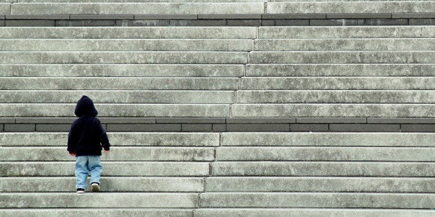 Child Walking Up Bottom of Stairs