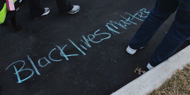 'Black Lives Matter' is drawn on the ground in chalk as protesters demonstrate against racism in the 'Reclaim MLK' march January 19, 2015 in outside the Ferguson Police Department in Ferguson, Missouri. Critics of police treatment of minority residents in the US took part in various demonstrations across the country coinciding with the observance of Martin Luther King Jr. Day, an American federal holiday marking the influential American civil rights leader's birthday. AFP PHOTO / MICHAEL B. THOMAS (Photo credit should read Michael B. Thomas/AFP/Getty Images)